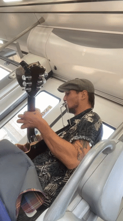Acoustic guitar and harmonica session on a Spanish commuter train