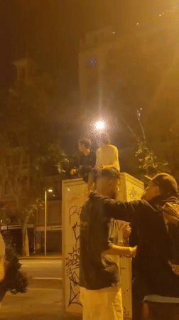 Late-night street gathering captured across Barcelona city center