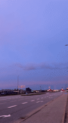 Dawn breaks over Aalborg roadside with colorful sky display
