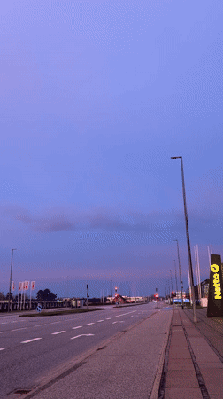 Dawn breaks over Aalborg roadside with colorful sky display