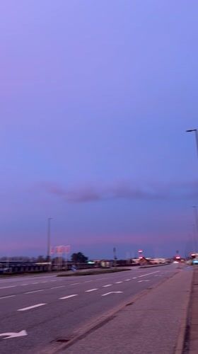 Dawn breaks over Aalborg roadside with colorful sky display
