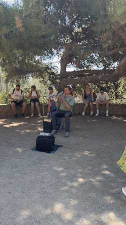 Street musician, city views captured across Barcelona morning