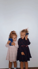 Pink dress, phone in hand, goofing around indoors in Sokolov