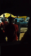 Rainy night at a Bukuru roadside market and transport hub