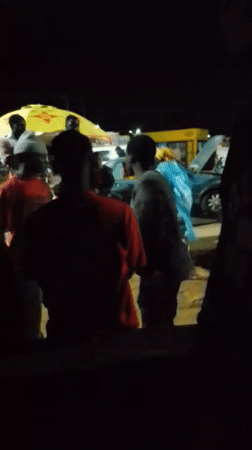 Rainy night at a Bukuru roadside market and transport hub
