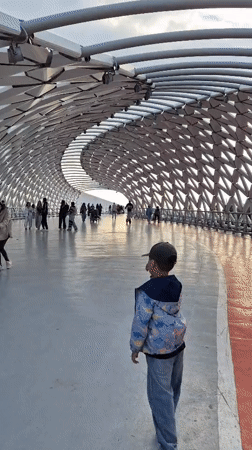 Afternoon at Astana's pedestrian bridge and park attractions