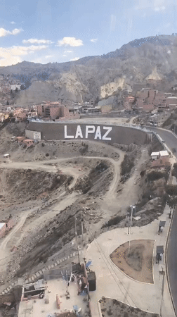 La Paz hillside cityscape, red rooftops cascading down steep slopes