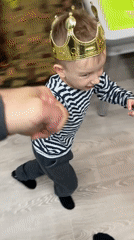 Child plays in gold crown at Russian home
