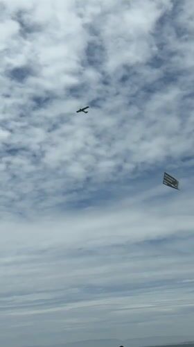 Banner-towing plane crosses the sky above Torrance on July 4th