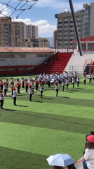 Youth marching band performs on sports field in La Paz