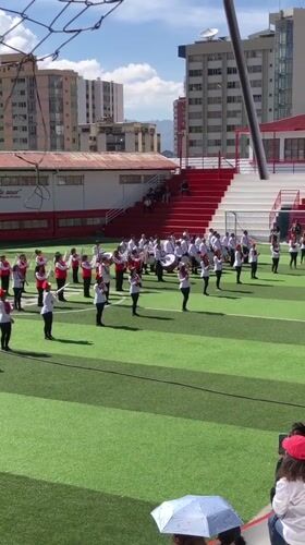 Youth marching band performs on sports field in La Paz