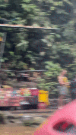 White water rafting group navigates tropical river in Indonesia