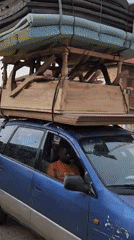 Moving day scene with loaded vehicle, man observed