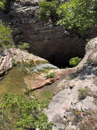 Rocky waterfall pool in Montenegro draws swimmers and sunbathers