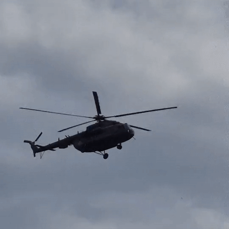 Military-style helicopter in flight over cloudy Russian skies
