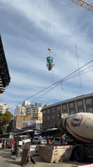 Crane lifts container near cement mixer in Buenos Aires