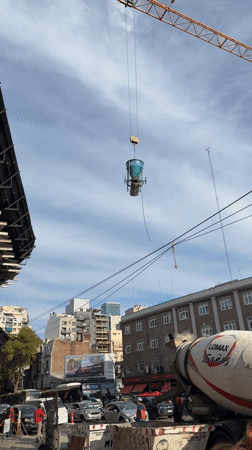 Crane lifts container near cement mixer in Buenos Aires
