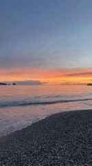 Woman documents sunset beach day in Budva, Montenegro