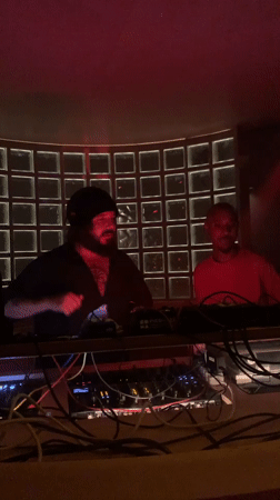 Late-night DJ set at a dimly lit Tel Aviv club