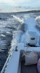White motorboat speeds across ocean near Nusa Penida