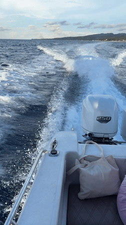 White motorboat speeds across ocean near Nusa Penida