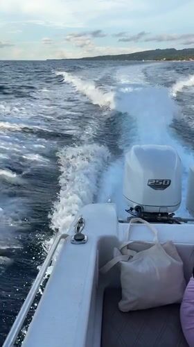 White motorboat speeds across ocean near Nusa Penida