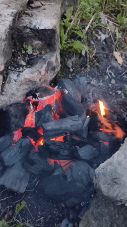 Campfire evening by the water in Narva at dusk