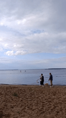Casual beach day with paddleboarding, sand play, and a Santa