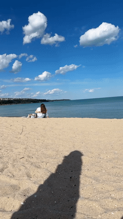 Woman enjoys sunny beach day in Varna, Bulgaria
