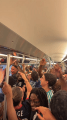Young adults celebrate on crowded Paris subway car