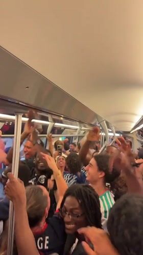 Young adults celebrate on crowded Paris subway car