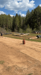 Protected workers play improvised soccer with propane tank target