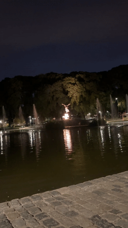 Nighttime fountains and illuminated statue captured at Buenos Aires park