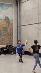 Traditional dancing in front of a poppy field mural, Santiago