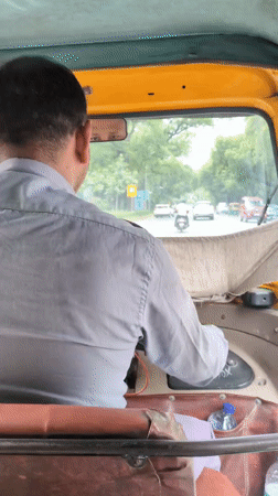 Morning street traffic in New Delhi, auto-rickshaws and all