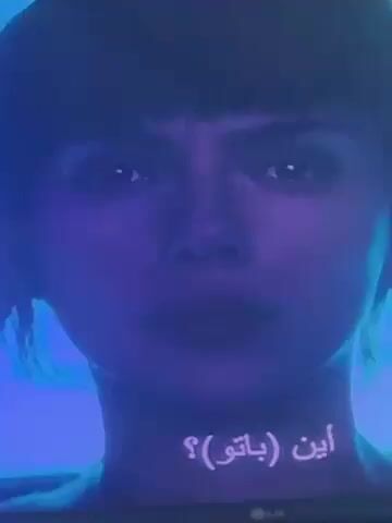The video is a close-up shot of a woman's face under blue lighting. She has dark hair with bangs and is looking directly at the camera. Arabic subtitles are visible at the bottom of the screen. The woman appears to be speaking, but the audio is muffled. An LG logo is visible in the bottom right corner, suggesting the video is being viewed on an LG television.