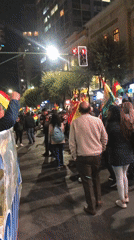 Nighttime flag-waving procession moves through La Paz streets