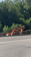 Roadside excavation work alongside urban construction activity