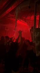 Moscow nightclub patrons dance under red lights Saturday evening