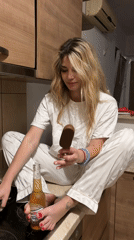 Woman enjoys late-night snacks on kitchen counter in Budva