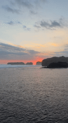 Sunrise to midday captured on Indonesian black sand beach
