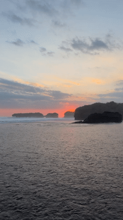 Sunrise to midday captured on Indonesian black sand beach