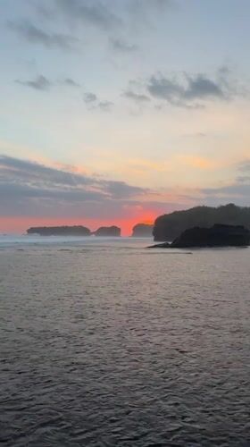 Sunrise to midday captured on Indonesian black sand beach