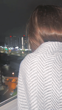 Family evening captured in Izhevsk apartment overlooking city lights