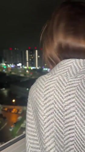 Family evening captured in Izhevsk apartment overlooking city lights