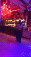 Couple dances in decorated Pattaya bar with colorful lighting