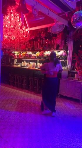 Couple dances in decorated Pattaya bar with colorful lighting