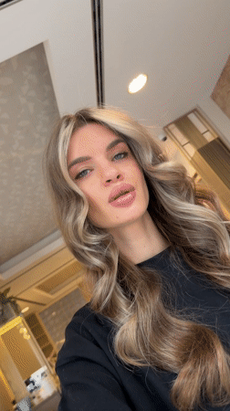 Woman records selfies at Berlin commercial location