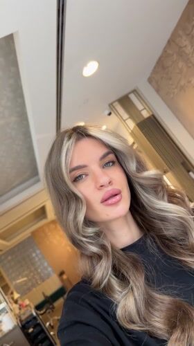 Woman records selfies at Berlin commercial location