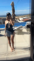 Woman photographs herself poolside in Cabo San Lucas